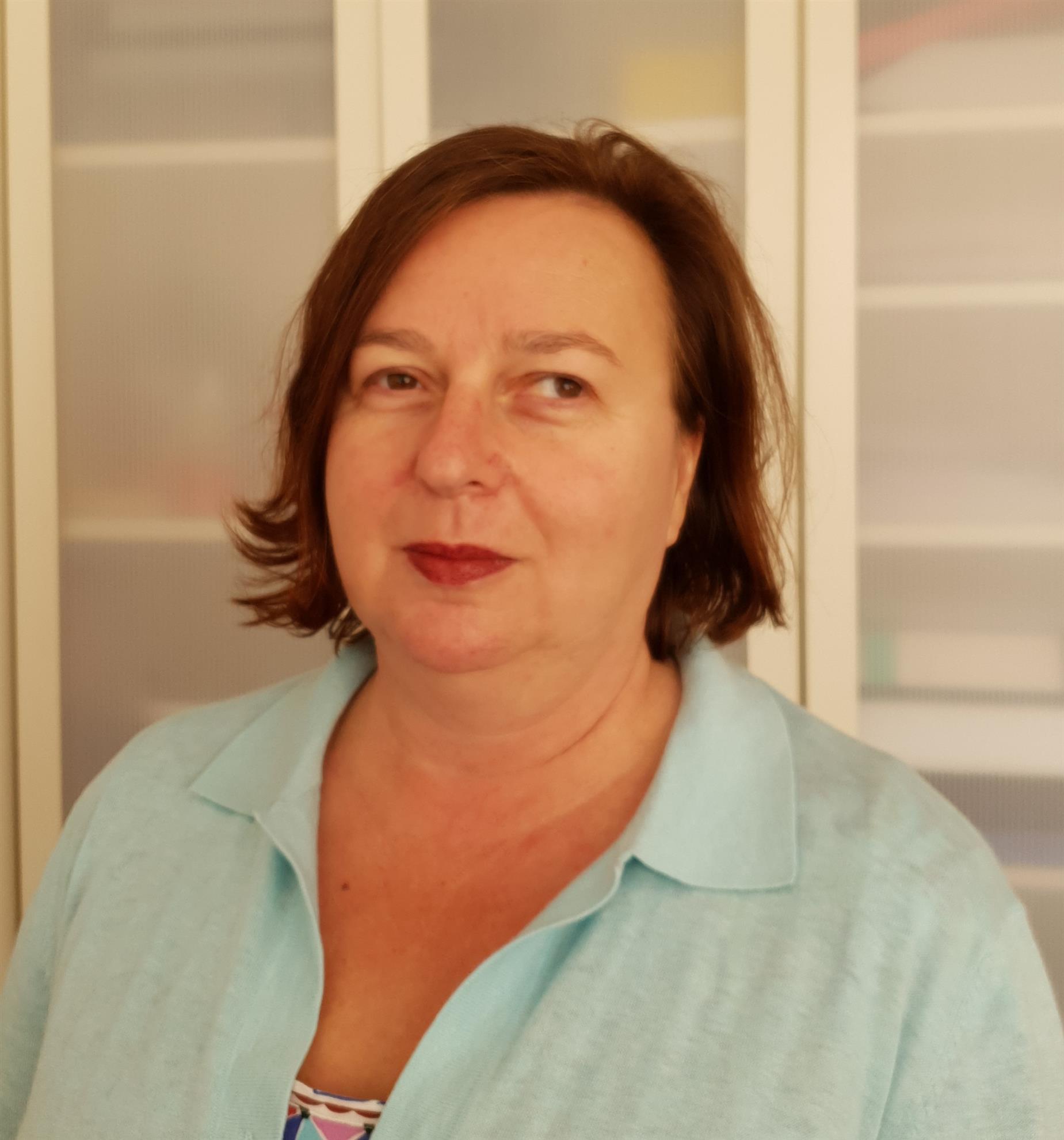 Headshot of Dr. Nataša Grgurina, a white woman with fine brown hair cut to a bob and wearing a light blue blouse