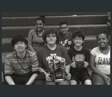 Middle school CS students posing with their robot